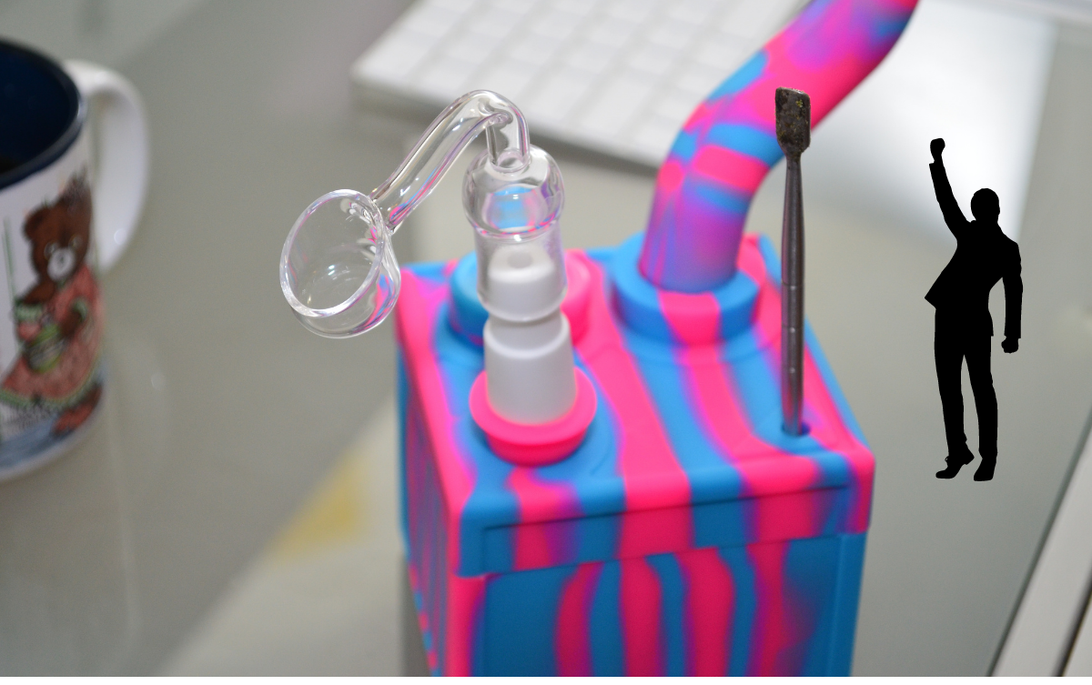 Banger dab rig that is pink and blue on glass table